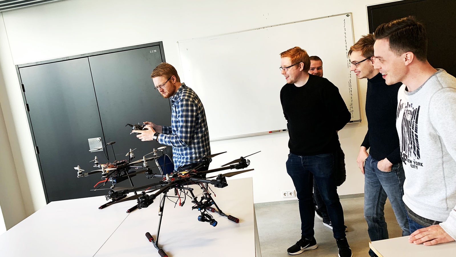 Students try out a drone in the RU Physics Lab. 