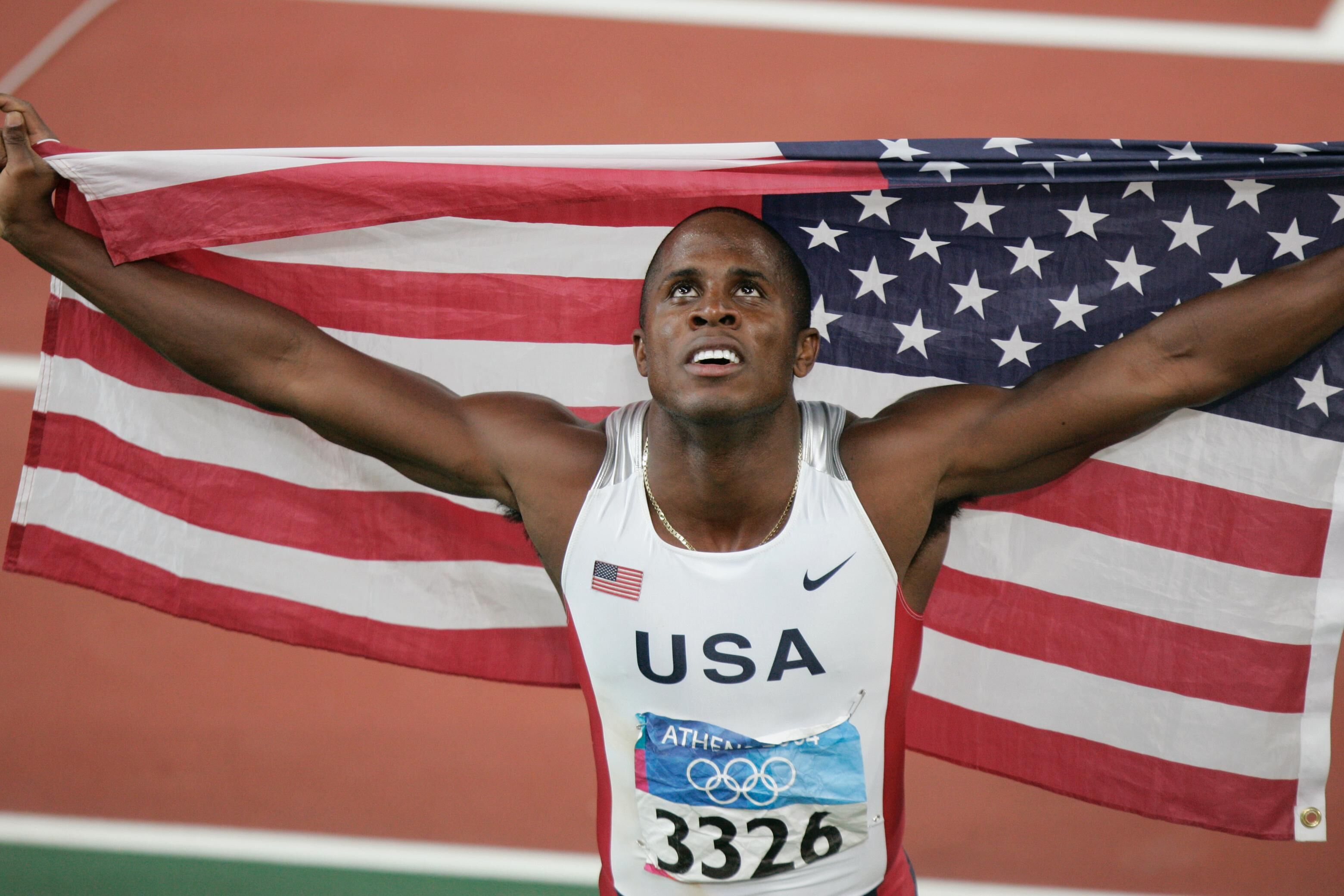 A man holds the American flag and celebrates