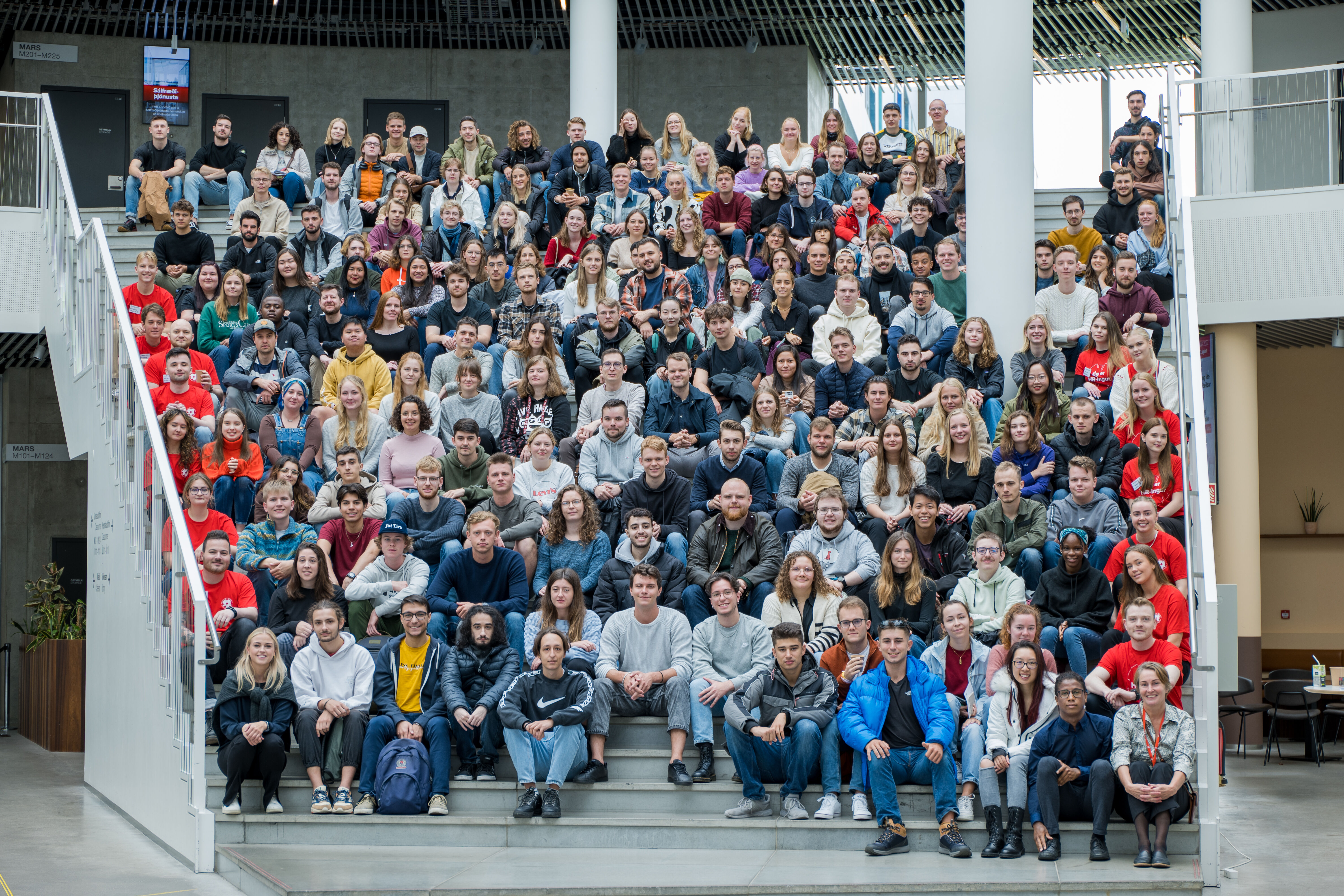 The 172 exchange students this autumn come from 28 countries sitting on the stairs at Reykjavík University