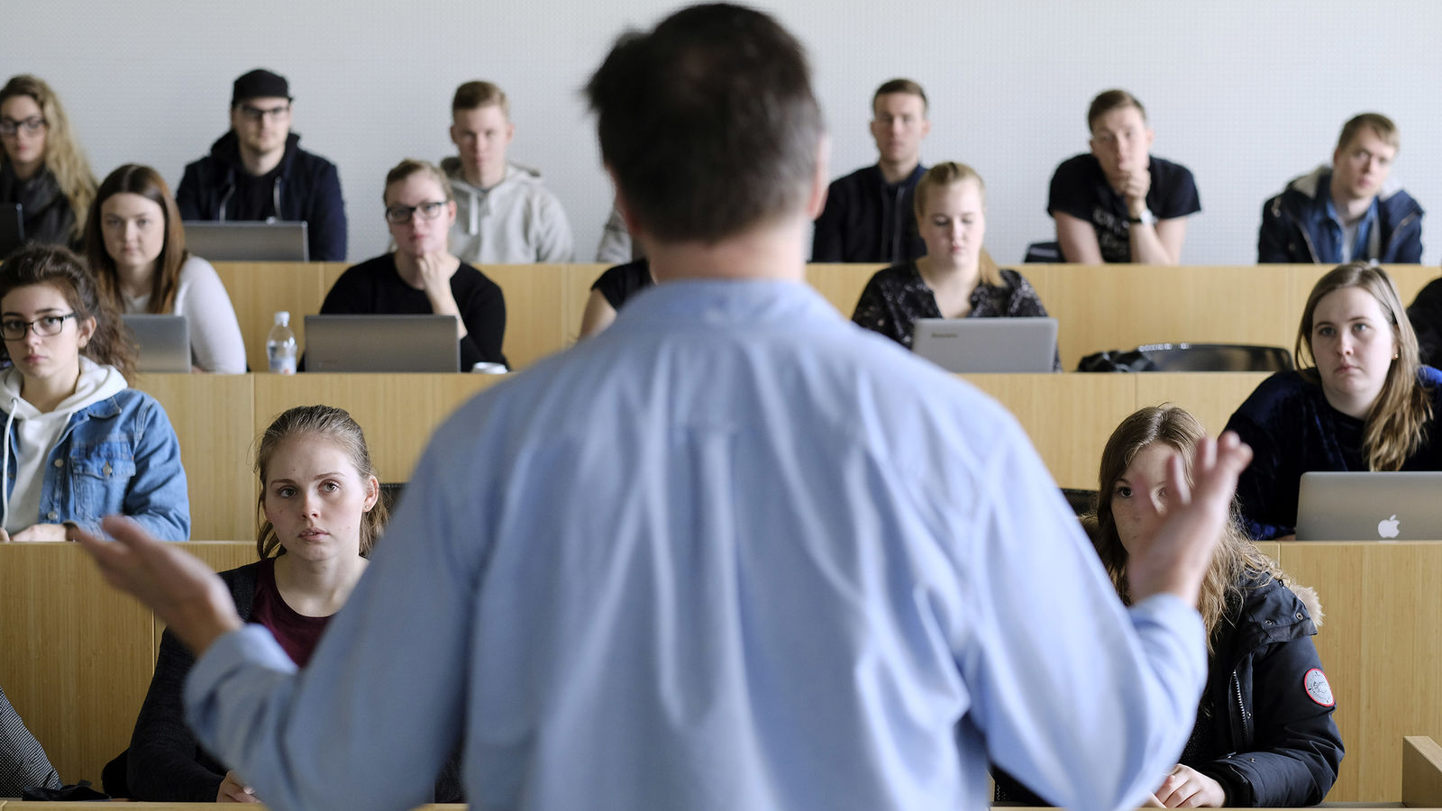 A teacher stands in front of a class